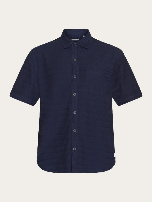Short sleeve Baggy shirt in Organic Cotton seersucker . Navy stripes